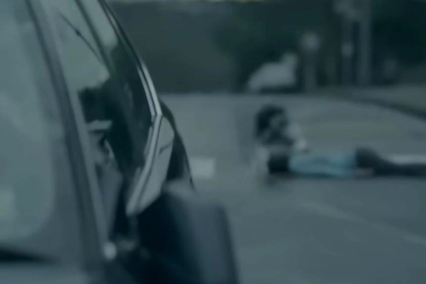  a dead person on the road after a car crash