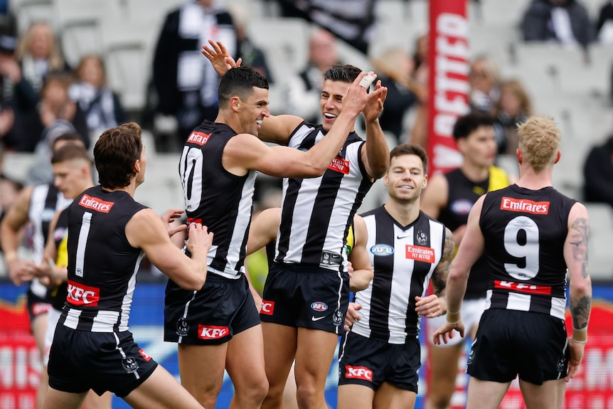 Scott Pendlebury and Nick Daicos celebrate a goal