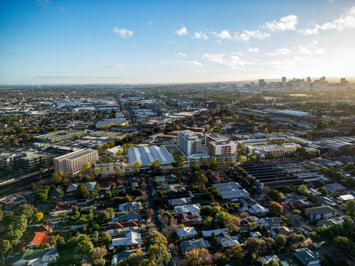 The architectural massing consists of three distinct forms: a mid-rise short-stay accommodation building fronting Anzac Highway; two apartment buildings in the centre, and a collection of terraces along the eastern boundary.