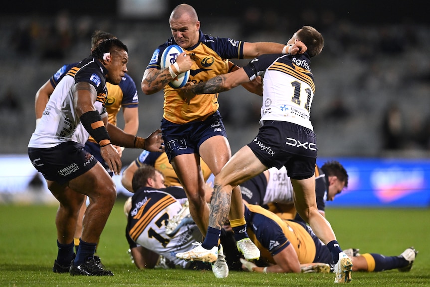 Dylan Pietsch runs with the ball as he meets the Brumbies defence during a 2026 match.