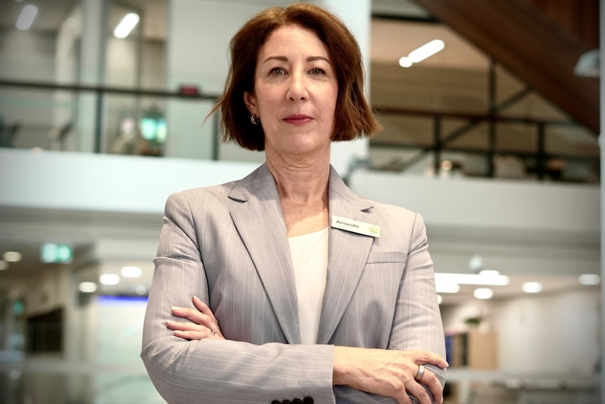 Amanda Bardwell wearing a grey suit jacket with arms cross.