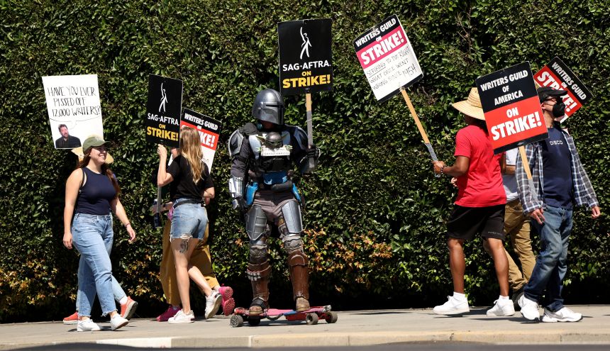 A person wearing The Mandalorian costume joins SAG-AFTRA actors and Writers Guild of America (WGA) writers as they walk the picket line during their ongoing strike outside Paramount Studios in Los Angeles, California, on September 8, 2023.