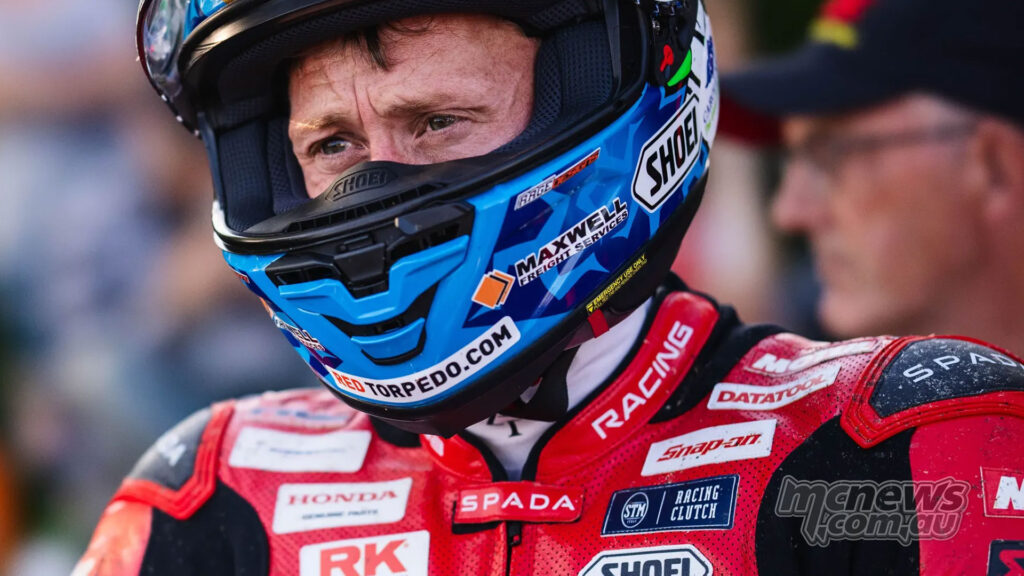 Dean Harrison wearing his helmet in the pits during TT 2026 qualifying.