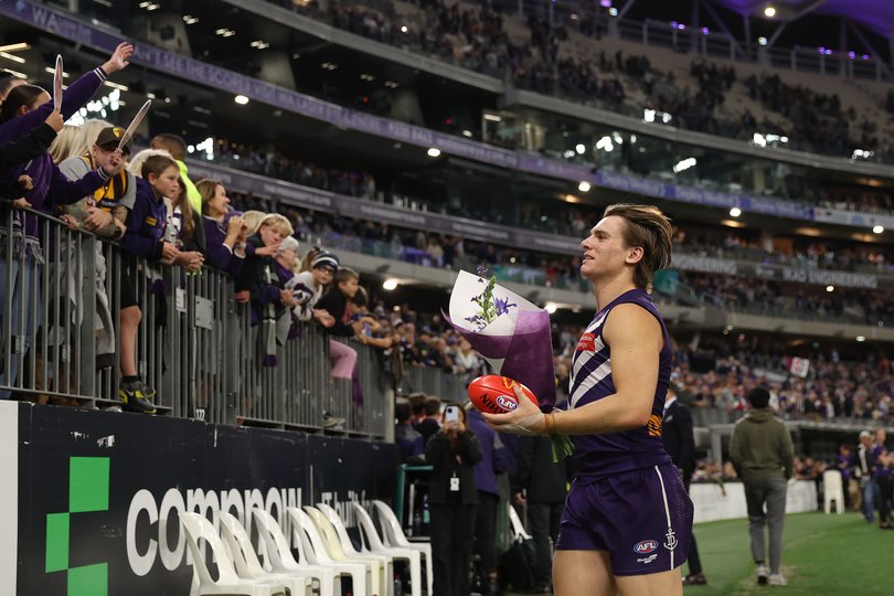 Caleb Serong and Freo players handed out bunches of flowers to crowd members after Thursday night’s win.
