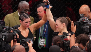 Ronda Rousey, of the United States, right, celebrates after defeating Gina Carano, of the Unite ...