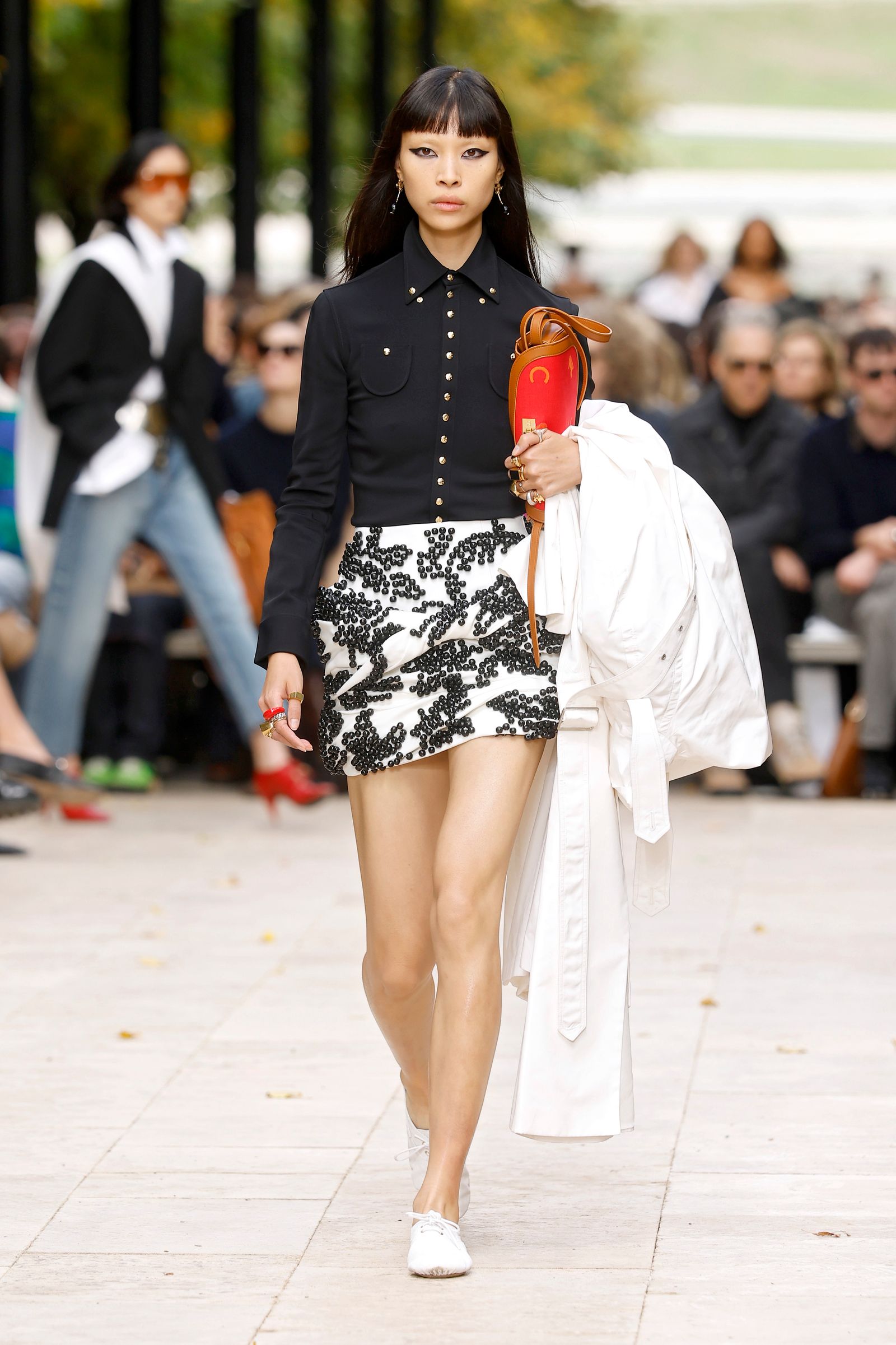Image may contain Kate Beaton Clothing Skirt Adult Person Shorts Pedestrian Miniskirt Black Hair and Hair