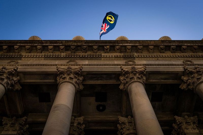The SA flag flies above South Australia's Parliament House.