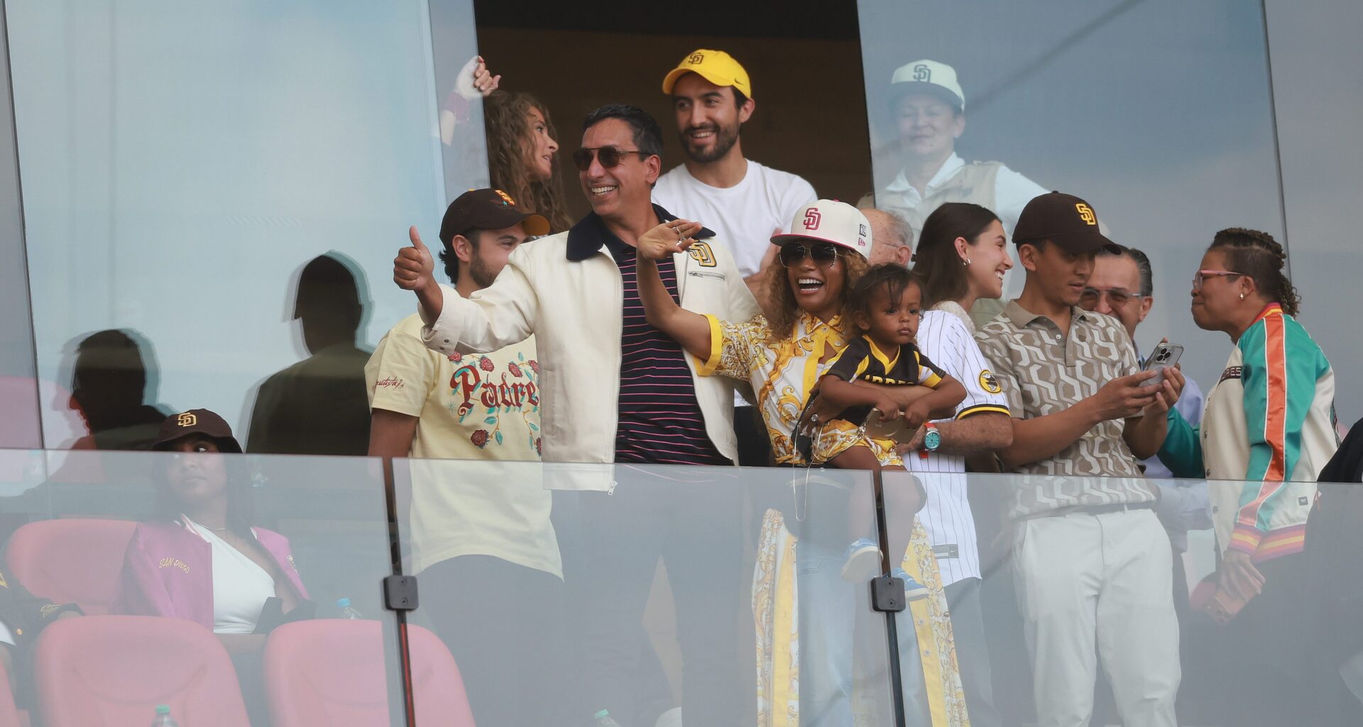 New owners of San Diego Padres José E. Feliciano and his wife Kwanza Jones wave in the stands during a game in Mexico City.