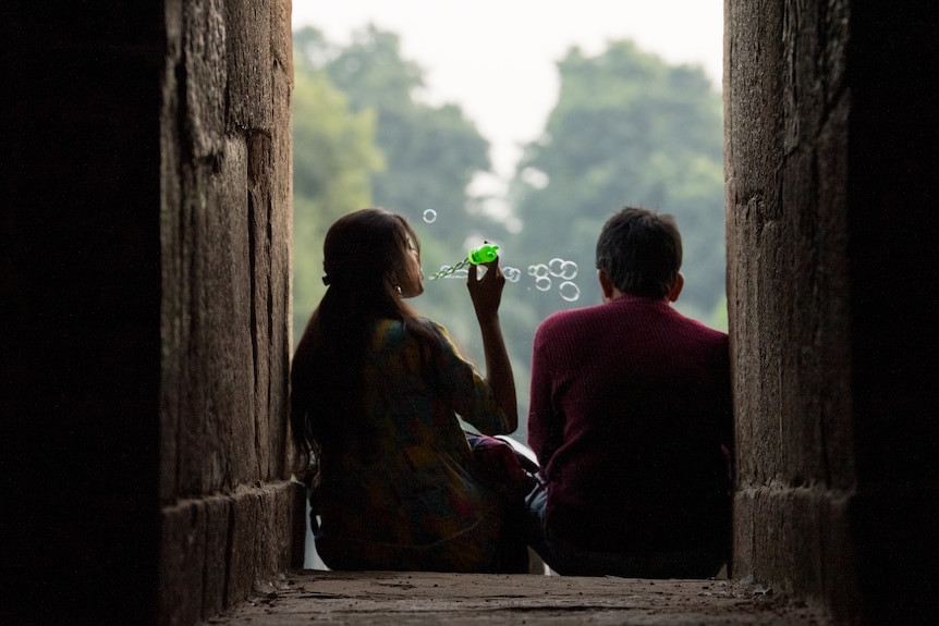 A woman blowing bubbles.