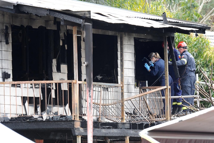 Forensic police take photos at house fire in Wagensveldt St, Slacks Creek