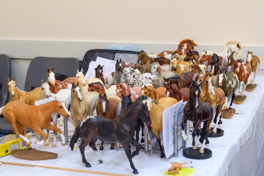 Table full of horses in black, brown, white and more