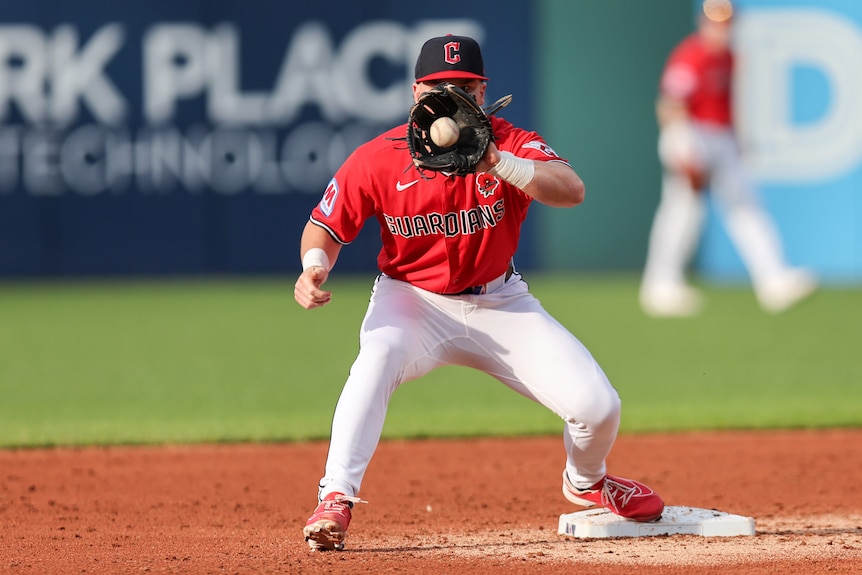 Travis Bazzana catches the ball in front of his face.