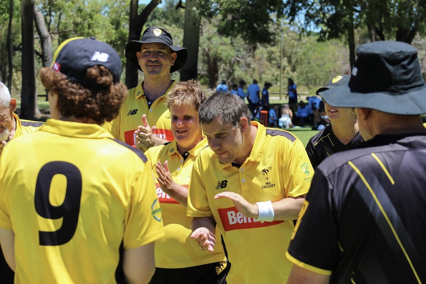 Blind cricket players are smiling and clapping