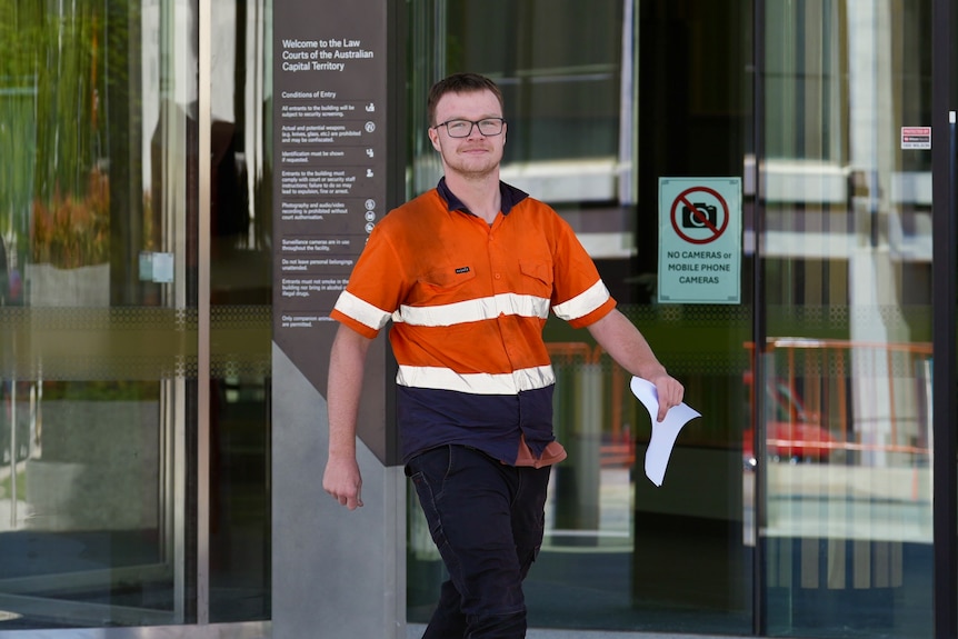 A young man leaves court.