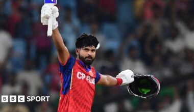 Shreyas Iyer lifting his bat to celebrate his century