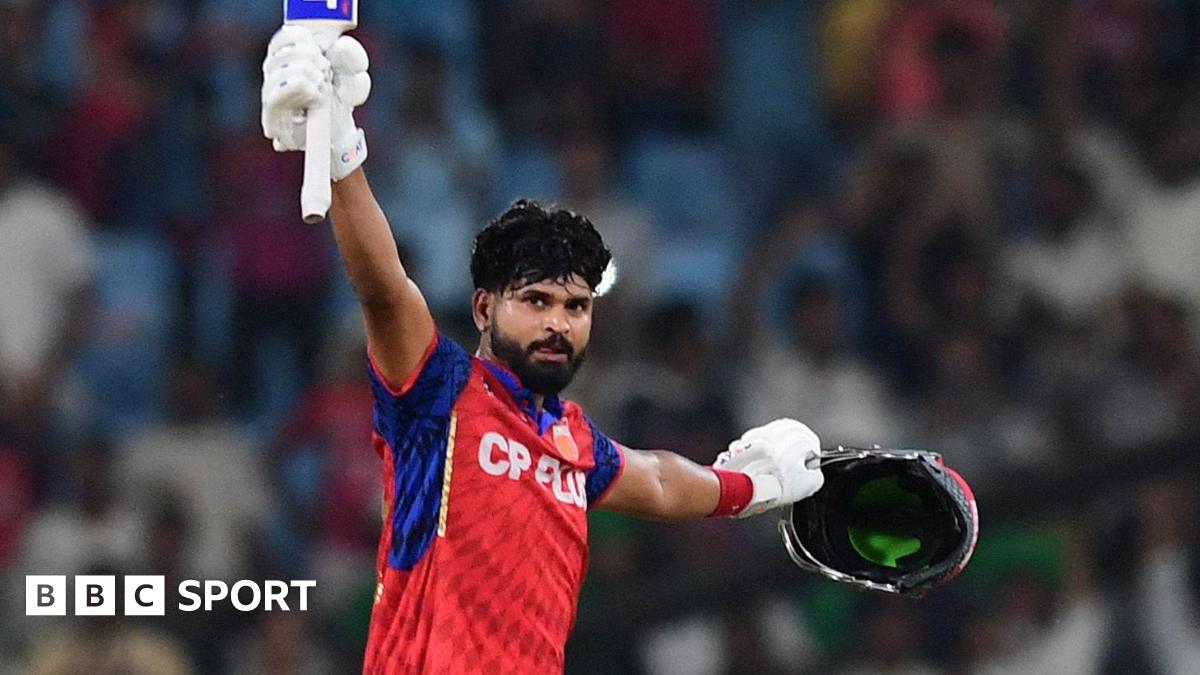 Shreyas Iyer lifting his bat to celebrate his century