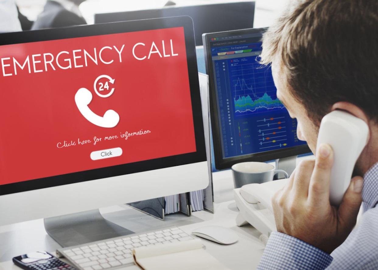 Emergency call dispatcher worker at terminal. -