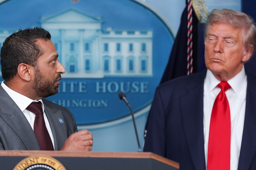 US President Donald Trump looks across at FBI director Kash Patel during a press conference at the White House.