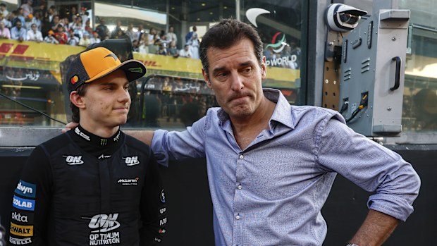 ABU DHABI, UNITED ARAB EMIRATES - DECEMBER 07: Oscar Piastri of Australia and McLaren and Mark Webber on the grid during the F1 Grand Prix of Abu Dhabi at Yas Marina Circuit on December 07, 2025 in Abu Dhabi, United Arab Emirates. (Photo by Andrew Ferraro/LAT Images)