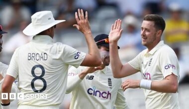 Stuart Broad and Ollie Robinson high-five each other while playing for England