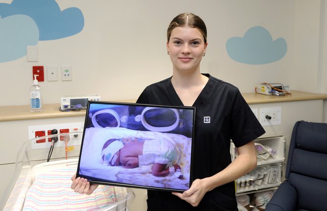 Graduate enrolled nurse Hollie Stein in the JHC neonatal unit where she was treated 19 years ago. 
