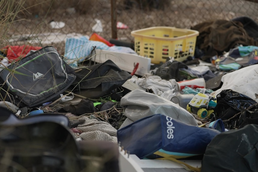 Dumped rubbish in a grass area.