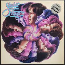 Album cover featuring a kaleidescope of band members faces in profile