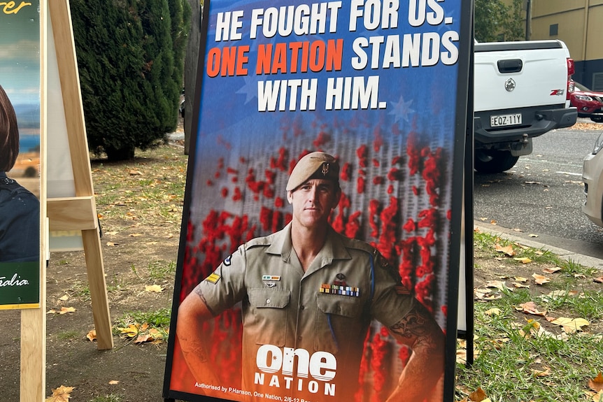 a corflute on a street with a soldier in uniform