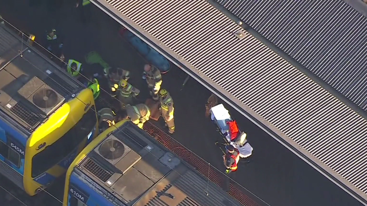 Schoolboy in critical condition after becoming trapped under train at North Melbourne Station