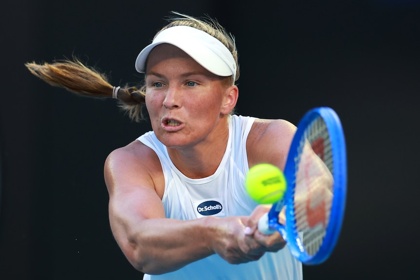 tennis player maddison inglis hits a backhand shot
