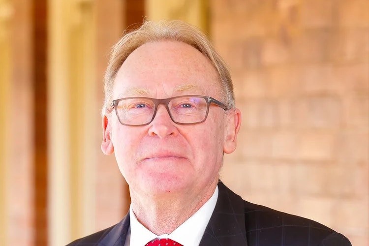 A man with glasses in a suit