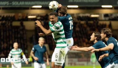 Motherwell's Sam Nicholson jumps with Celtic's Aaron Trusty