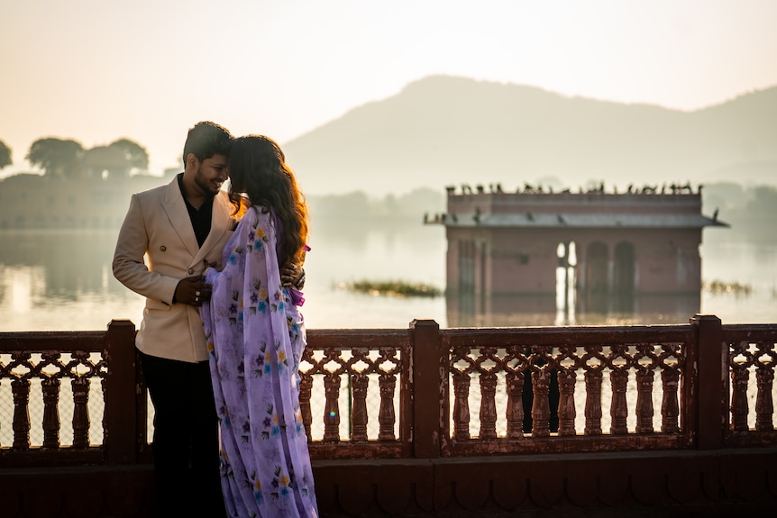 Two people in front of a landmark.