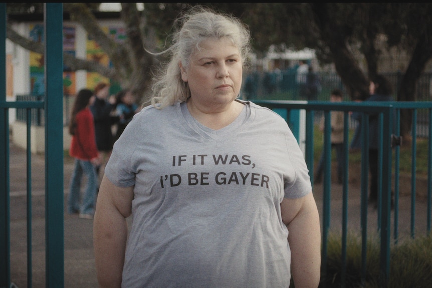 Wearing a tshirt that reads: If it was, I'd be gayer, Urzila stands looking into the distance.