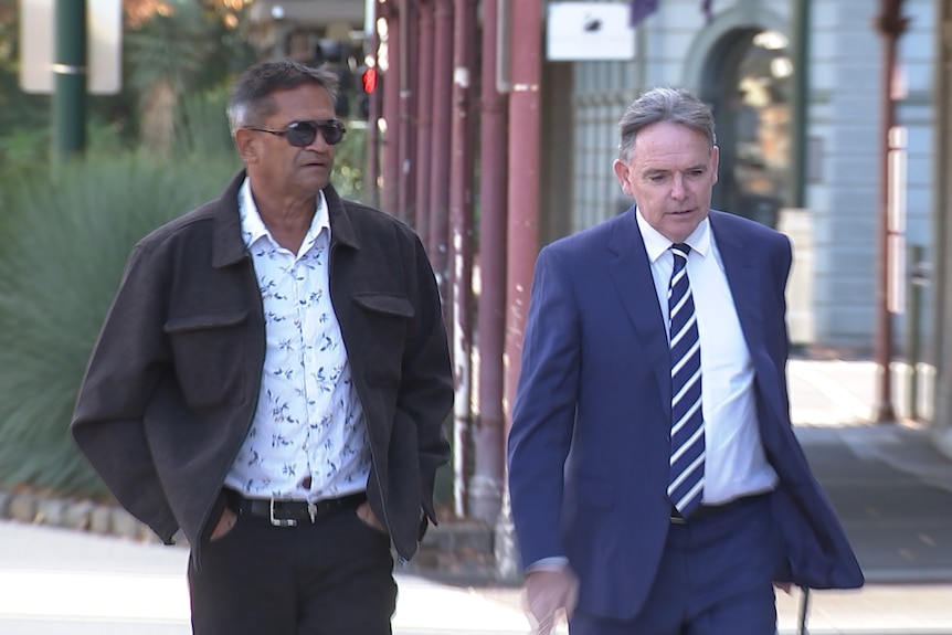 Two men walk into court
