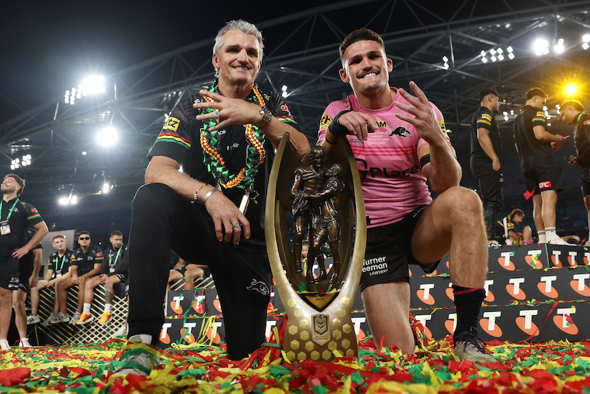Nathan Cleary (right) of the Panthers poses with the Provan-Summons Trophy alongside his father and coach Ivan Cleary 
