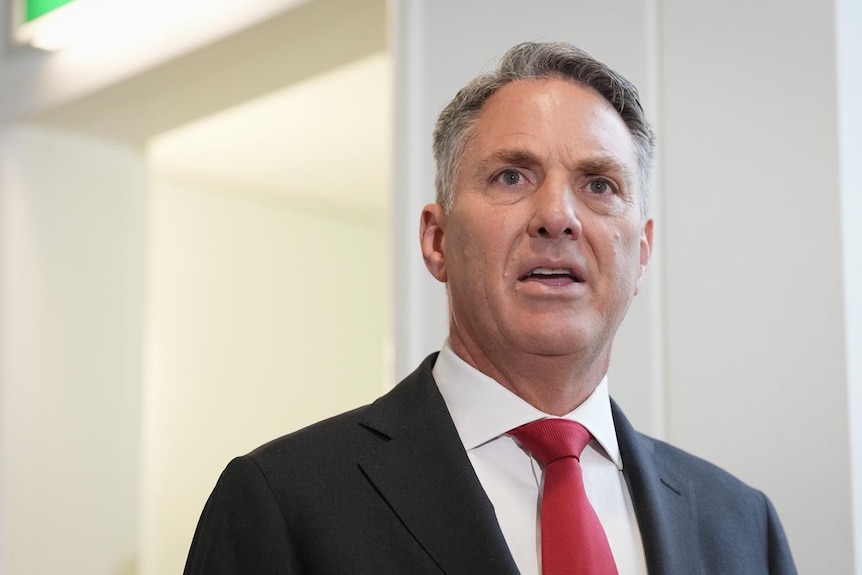 a male politician wearing a red tie and suit