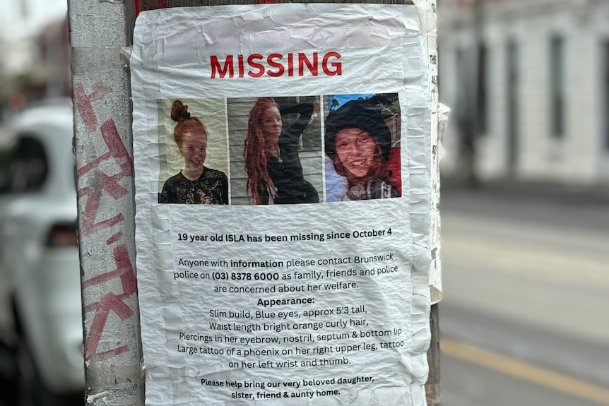 A poster about a missing woman stuck to a power pole
