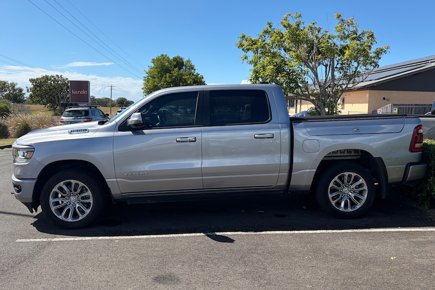 A big silver ute parked in a car park