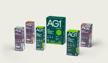 Multiple boxes of AG1 and AGZ wellness supplements arranged against a neutral background