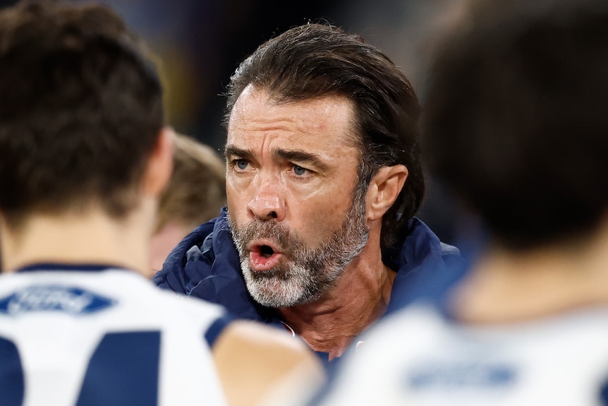Chris Scott speaks to his players in a huddle