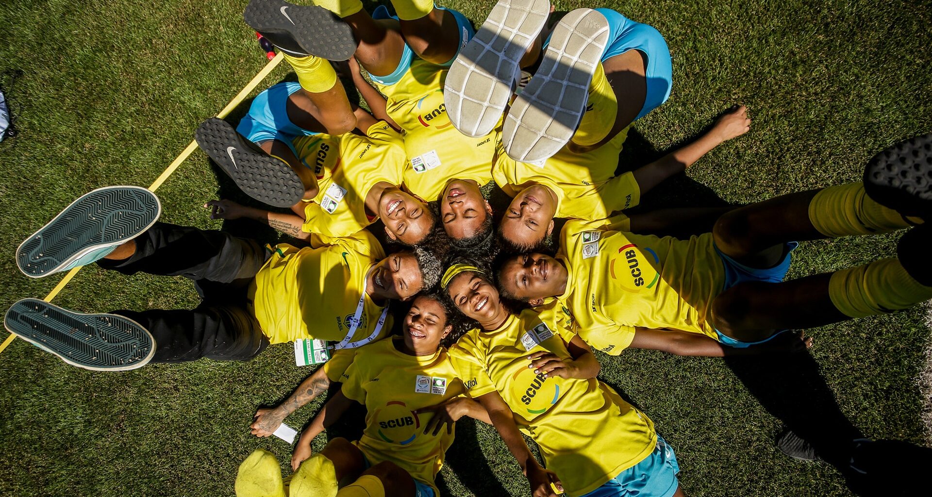 a number of players from the Street Child World Cup lying down with their feet in the air