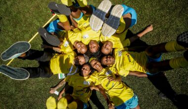 a number of players from the Street Child World Cup lying down with their feet in the air