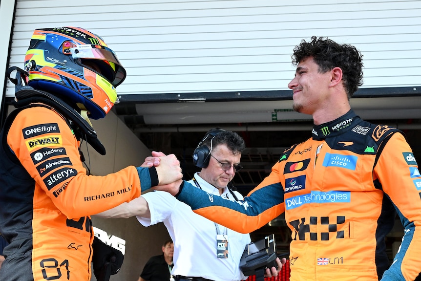 Oscar Piastri shakes the hand of Lando Norris
