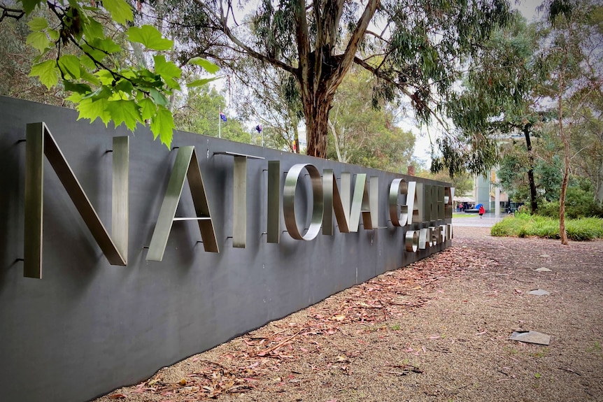A large concrete sign with letters saying National Gallery of Australia.