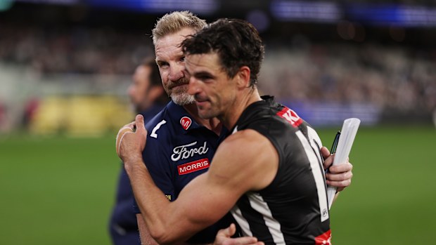 Geelong assistant coach Nathan Buckley and Collingwood's Scott Pendlebury.