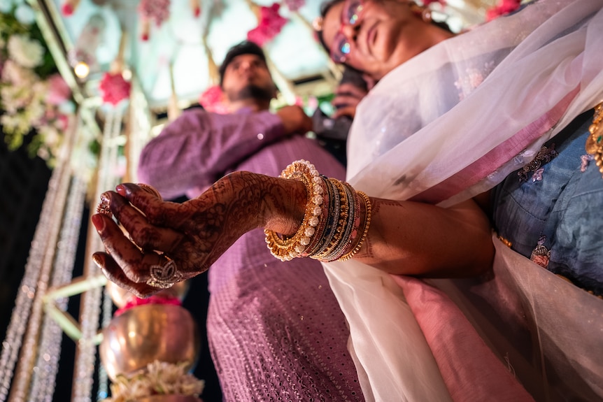 Jewellery on a wedding guest's wrist.
