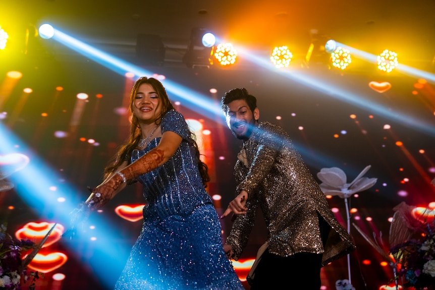 Two people dancing on stage. 