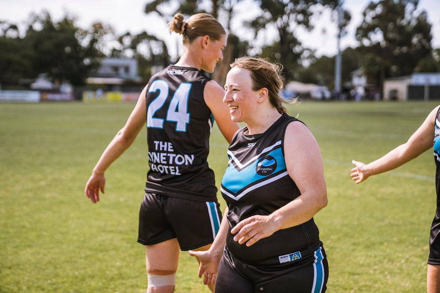 Wedge-Tailed Eaglse president walking on the footy field.