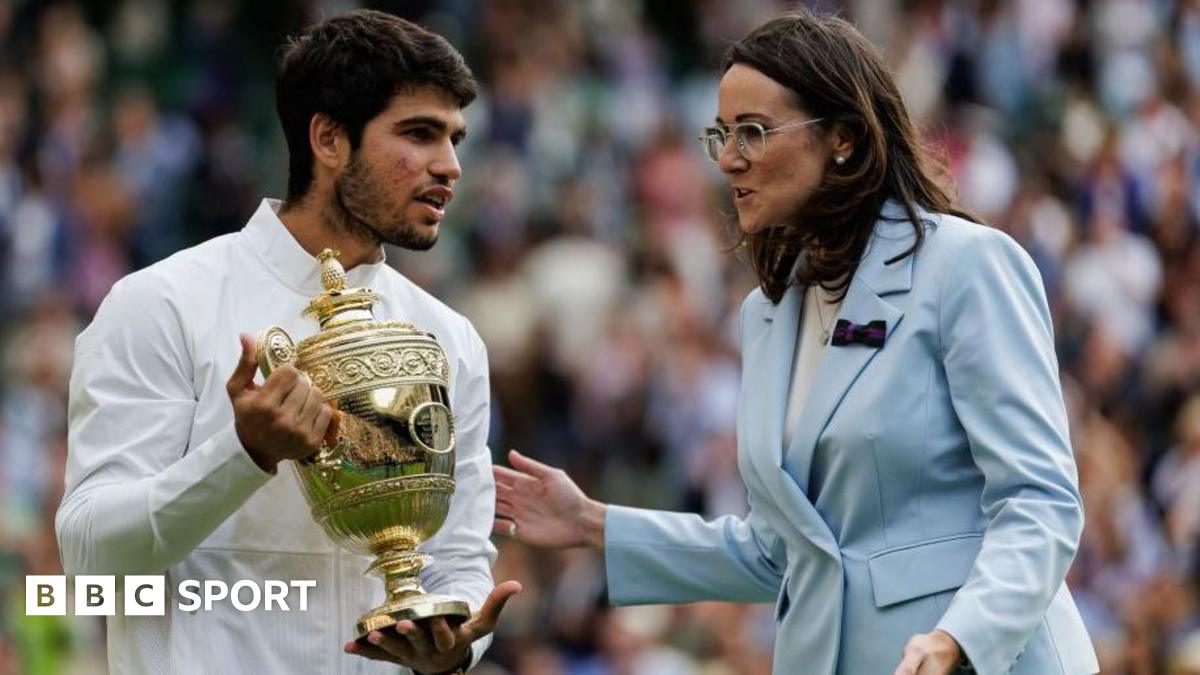 Carlos Alcaraz of Spain talks to AELTC chief executive Sally Bolton while holding the Wimbledon winner's trophy